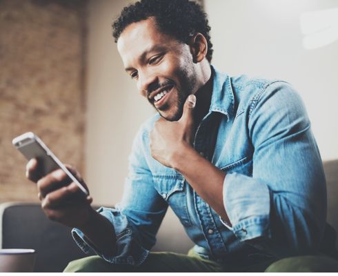 a person looking at their cell phone in their hand